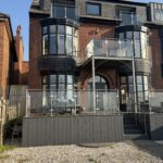 Modern brick exterior with glass balconies and spacious outdoor area